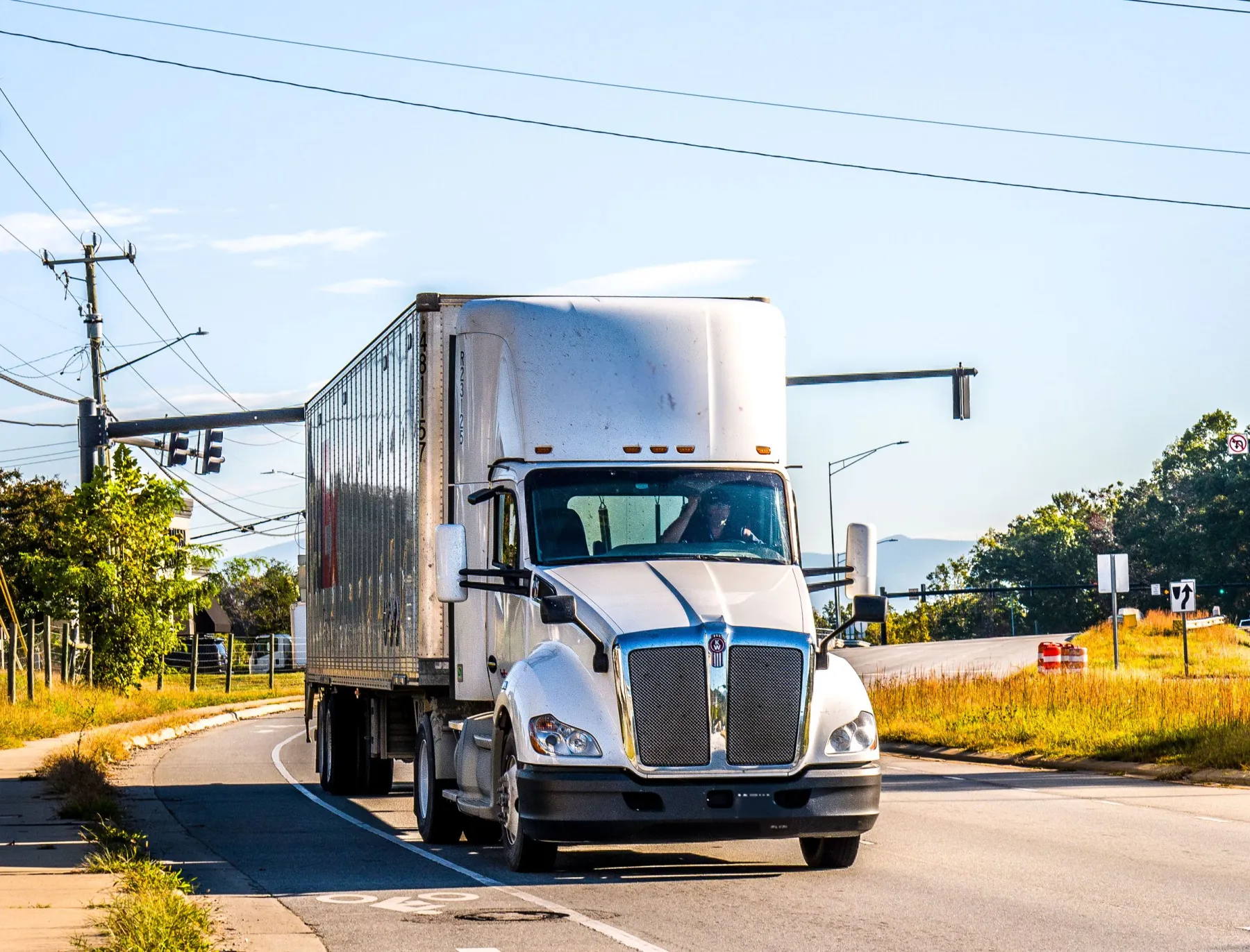 A white semi truck on a sunny road